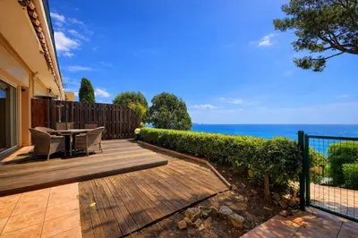 a patio with a table and chairs and the ocean at Villa Cannes I Deluxe Seafront - Sea View - Garden & Terrace -Prime Location- in Cannes