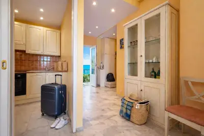 a kitchen with a blue suitcase in a room at Villa Cannes I Deluxe Seafront - Sea View - Garden & Terrace -Prime Location- in Cannes