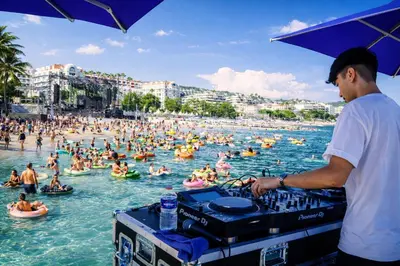 a man standing in the water at a crowded beach at Villa Cannes I Deluxe Seafront - Sea View - Garden & Terrace -Prime Location- in Cannes