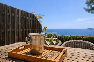 a tray with two glasses of wine on a table at Villa Cannes I Deluxe Seafront - Sea View - Garden & Terrace -Prime Location- in Cannes