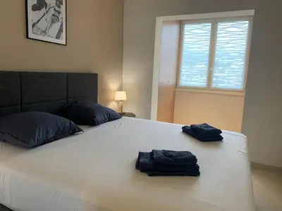 a large white bed with two blue towels on it at Ô Béatrice Croisette in Cannes