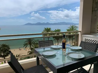 a dining table with a view of the beach at Ô Béatrice Croisette in Cannes