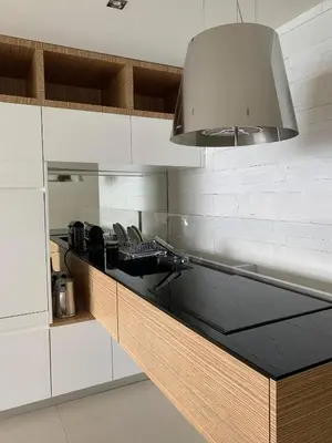 a kitchen with white cabinets and a sink at Ô Béatrice Croisette in Cannes