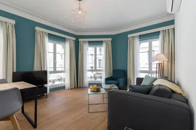 a living room with a couch and a table at Florella Antibes Apartment in Cannes