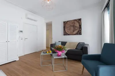 a living room with a couch and a table at Florella Antibes Apartment in Cannes