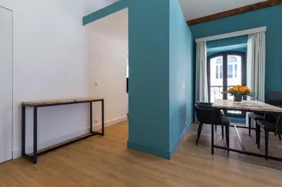 a dining room with a blue wall and a table at Florella Antibes Apartment in Cannes