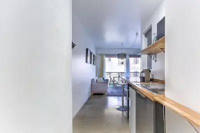 a kitchen with white walls and a counter top at Studio Cosy Merle in Cannes
