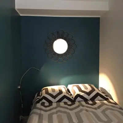 a bedroom with a bed with a mirror on the wall at Studio Cosy Merle in Cannes
