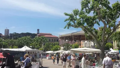 a group of people walking around a market with umbrellas at Studio Cosy Merle in Cannes