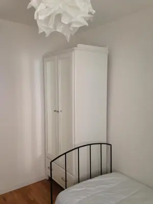 a bedroom with a bed and a chandelier at Suquet Charm in Cannes