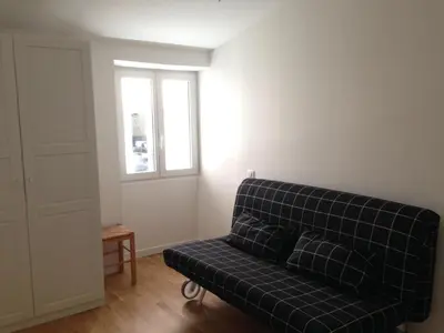 a blue couch in a room with a window at Suquet Charm in Cannes