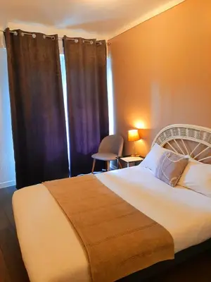 a bedroom with a large bed and a window at Hôtel Bellevue Cannes in Cannes