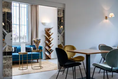 a living room with a table and chairs at Hotel Albert 1er in Cannes