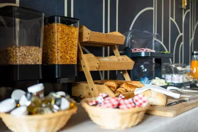 a table topped with baskets of bread and other foods at Hotel Albert 1er in Cannes