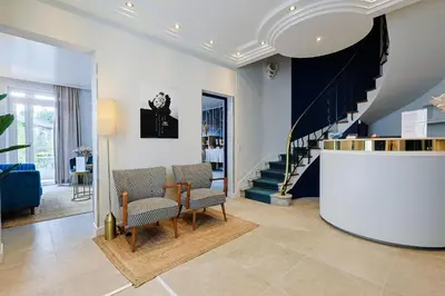 a living room with two chairs and a staircase at Hotel Albert 1er in Cannes