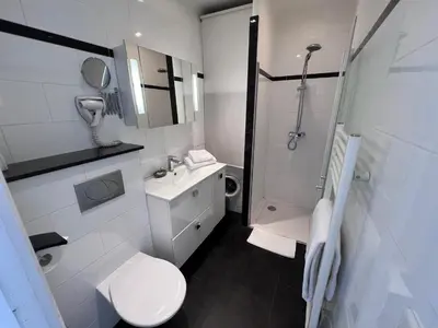 a bathroom with a toilet and a sink and a shower at Riviera Eden Palace in Cannes