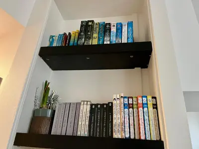 a book shelf filled with lots of books at Appartement Le Suquet proche Croisette in Cannes