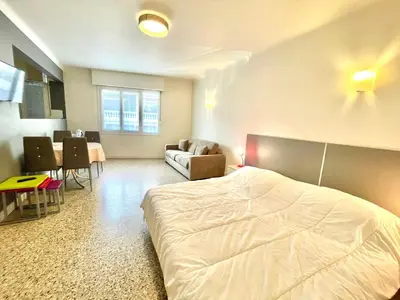 a bedroom with a bed and a couch and a table at Themis by Welcome to Cannes in Cannes