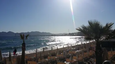 a beach with a bunch of chairs and the ocean at Cannes Riviera in Cannes