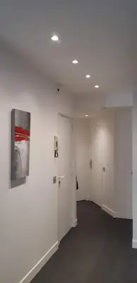 a room with white walls and a painting on a wall at Cannes Riviera in Cannes