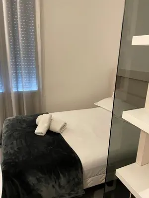 a bedroom with a bed with two towels on it at Hôtel Anna Livia in Cannes