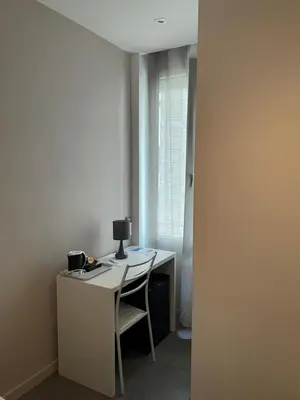 a desk with a chair and a computer on it at Hôtel Anna Livia in Cannes
