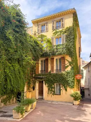 a yellow house with ivy on the side of it at Charming house in Cannes