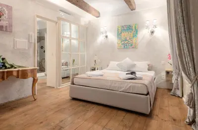 a bedroom with a bed and a table and a window at Charming house in Cannes