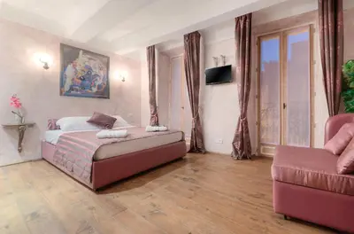 a bedroom with a bed and a couch at Charming house in Cannes