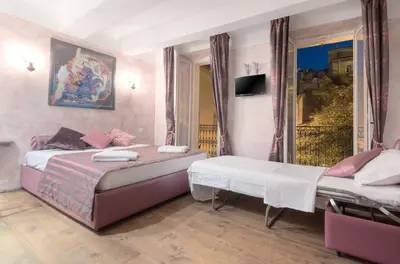 a bedroom with two beds and a tv in it at Charming house in Cannes