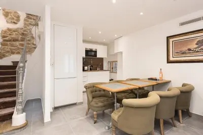 a kitchen and dining room with a table and chairs at Charming house in Cannes