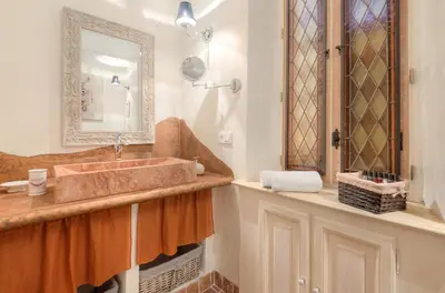 a bathroom with a sink and a mirror at Charming house in Cannes