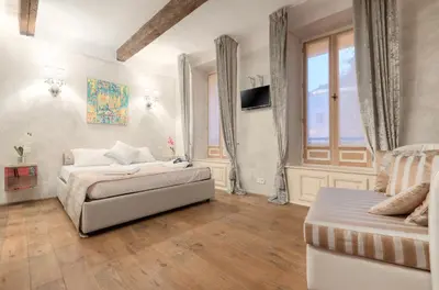 a bedroom with two beds and a couch and a window at Charming house in Cannes