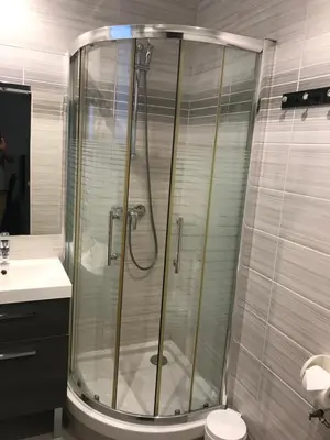 a bathroom with a shower and a toilet and a sink at Hotel Lutetia in Cannes