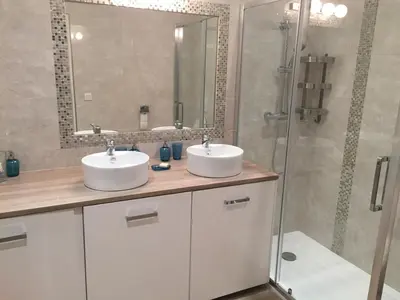 a bathroom with two sinks and a shower at Palme d'hote in Cannes
