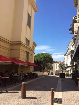 a street with tables and chairs and a building at Palme d'hote in Cannes