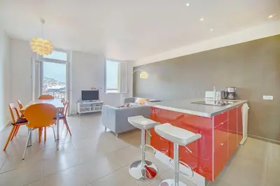 a kitchen and living room with a table and chairs at IMMOGROOM - SEA View on the Port - Next to the beaches - AC - Wifi in Cannes