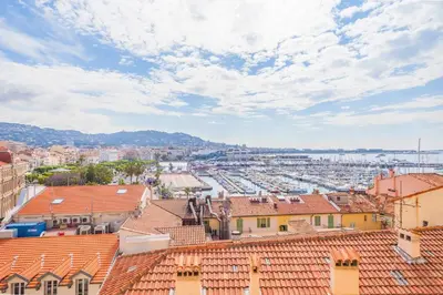 a view of a city with roofs and a harbor at IMMOGROOM - SEA View on the Port - Next to the beaches - AC - Wifi in Cannes