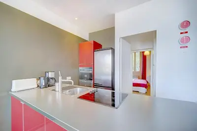 a kitchen with a counter top with a sink at IMMOGROOM - SEA View on the Port - Next to the beaches - AC - Wifi in Cannes