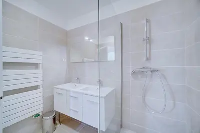 a white bathroom with a shower and a sink at IMMOGROOM - SEA View on the Port - Next to the beaches - AC - Wifi in Cannes