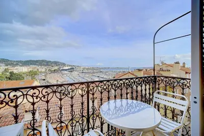 a balcony with a white table and chairs at IMMOGROOM - SEA View on the Port - Next to the beaches - AC - Wifi in Cannes