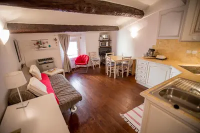 a kitchen and living room with a couch and a table at Le Suquet Style by Connexion in Cannes