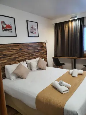 a bedroom with a large bed with towels on it at Resothel Group in Le Cannet