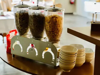 a table with three containers of food and plates at Resothel Group in Le Cannet