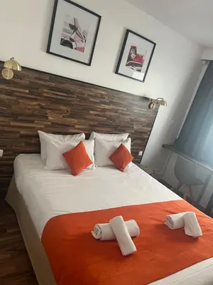 a bedroom with a bed with two towels on it at Resothel Group in Le Cannet