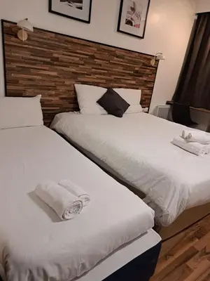 two beds sitting next to each other in a bedroom at Resothel Group in Le Cannet