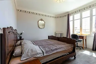 a bedroom with a bed and a desk and a mirror at Villa Lerina in Cannes