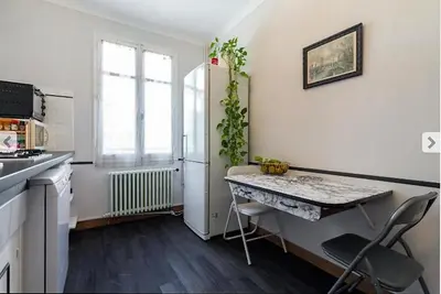 a small kitchen with a table and a window at Villa Lerina in Cannes