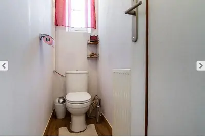 a small bathroom with a toilet and a window at Villa Lerina in Cannes