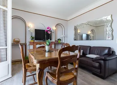 a living room with a wooden table and a couch at Villa Lerina in Cannes